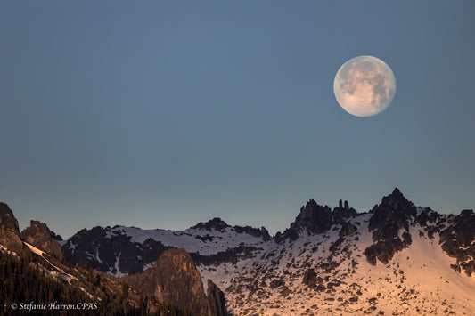 Moon setting over mountains of Kokanee Glacier Provincial Park
